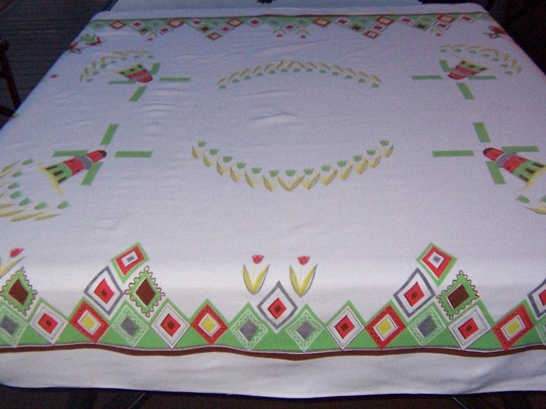 yellow and orange rectangle tablecloth tulips and adorable dutch boy and girl.In green vintage tablecloth all about Holland with windmills