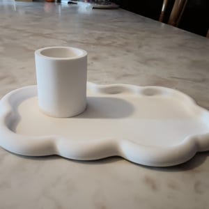 May include: White ceramic tray with a cloud-like shape and a smaller white ceramic cylinder in the center.