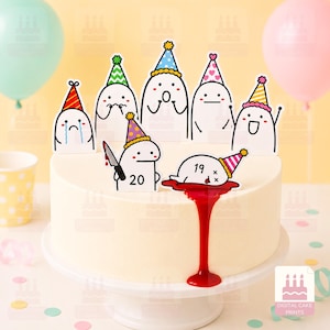 May include: A round white cake topped with seven cartoon character cake toppers wearing colorful party hats. One character holds a knife with the number 20, while another lies flat with the number 19 and red liquid dripping down the side.