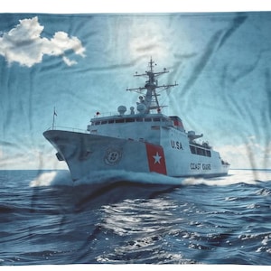 May include: A white Coast Guard ship with the words "U.S.A." and "Coast Guard" on the side, sailing on a blue ocean with white clouds in the sky.