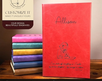 May include: A red leather-like journal with the name Allison engraved at the top and a line art illustration of a person writing below. The text reads: I can shake off everything as I write; my sorrows disappear, my courage is reborn. Anne Frank.