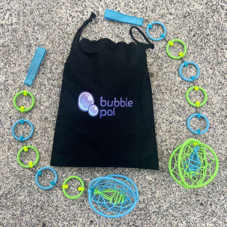 May include: A black drawstring bag with the text bubble poi printed in purple and blue, accompanied by two poi sets. Each set features a light blue handle strap, a chain of alternating lime green and light blue rings, and a spherical cage.