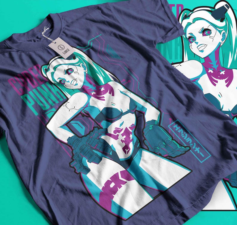May include: A navy blue t-shirt with a cyberpunk graphic of a female character with teal hair and accents. The design includes the text "CYBER PUNK" in teal and pink, along with Japanese text. A tag with the word "LARGE" is attached.