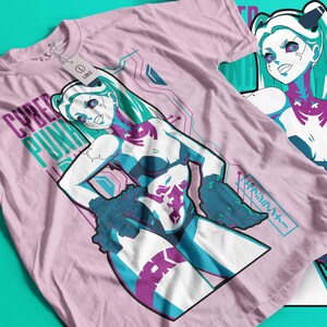 May include: Pale pink t-shirt featuring a female anime character in blue, purple, and white. The text "CYBER PUNK" is printed on the shirt. Another t-shirt with the same design is visible in the background.