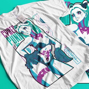 May include: White t-shirt with a graphic of a female anime-style character with teal hair and accents. The shirt has the words "CYBER PUNK" in purple and teal. Another shirt is visible in the background.