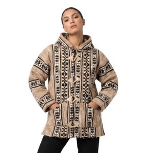May include: A hooded jacket featuring a tan and brown woven pattern with vertical black and white geometric stripes. The garment includes long sleeves, two front pockets, and four light-colored toggle closures down the center front.