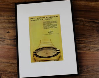 Anuncio impreso auténtico enmarcado del Omega Constellation "Claws" Full Gold Edition de 1984