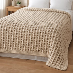 Könnte beinhalten: Eine beige Einzelbettdecke mit einem gewebten, strukturierten Design. Die Decke ist über ein Bett drapiert und zeigt ihr rechteckiges Muster. Die Maße betragen 127 cm x 178 cm.