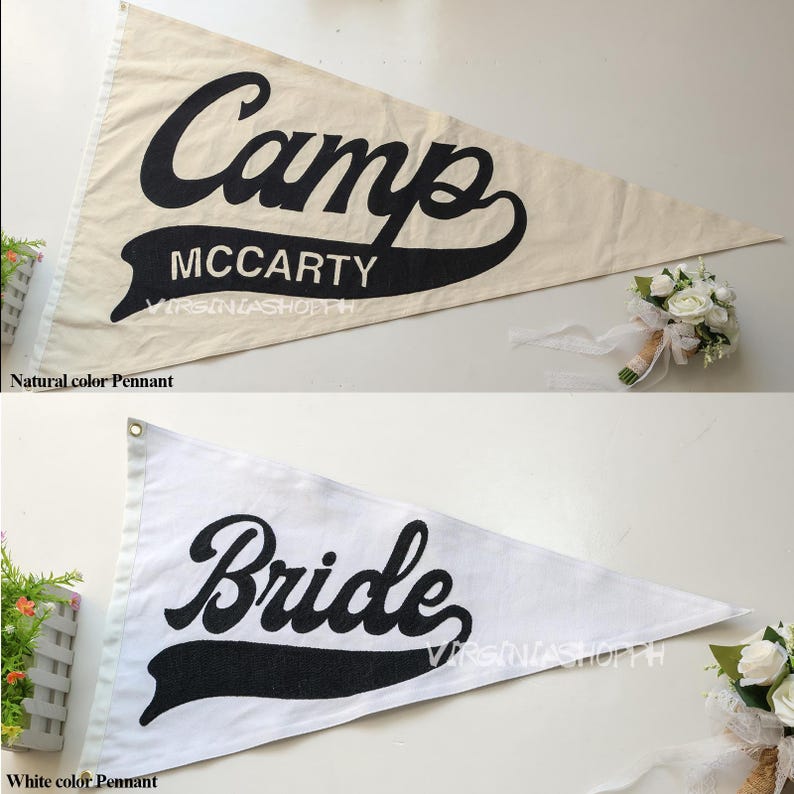 May include: Two triangular pennants, one in natural beige and one in white, both featuring black lettering. The top pennant displays the text Camp MCCARTY, while the bottom pennant displays the word Bride. Both pennants have a banner graphic.