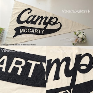 May include: A triangular off-white pennant featuring the black text Camp MCCARTY in a script and block font combination. The lettering has a textured, raised appearance. The design includes a banner shape behind the word MCCARTY.