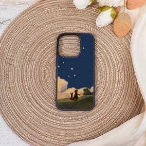 May include: A black phone case featuring a whimsical illustration of a boy and a fox sitting on a grassy hill under a starry night sky. The design includes clouds and a tree, creating a storybook aesthetic.
