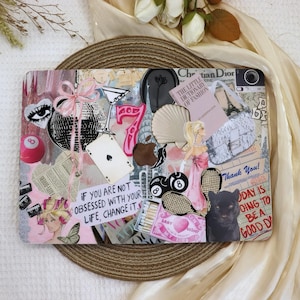May include: A laptop decorated with colorful stickers and images. The stickers include a pink 8 ball, a playing card, a martini glass, a black panther, a heart with the words "Baby My Light", and a quote that reads "If you are not obsessed with your life, change it."