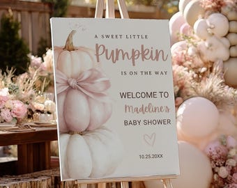 May include: An easel holds a sign with the text "A Sweet Little Pumpkin is on the Way" and "Welcome to Madeline's Baby Shower." The sign features a watercolor illustration of pumpkins. The scene includes balloons, flowers, and pumpkins.