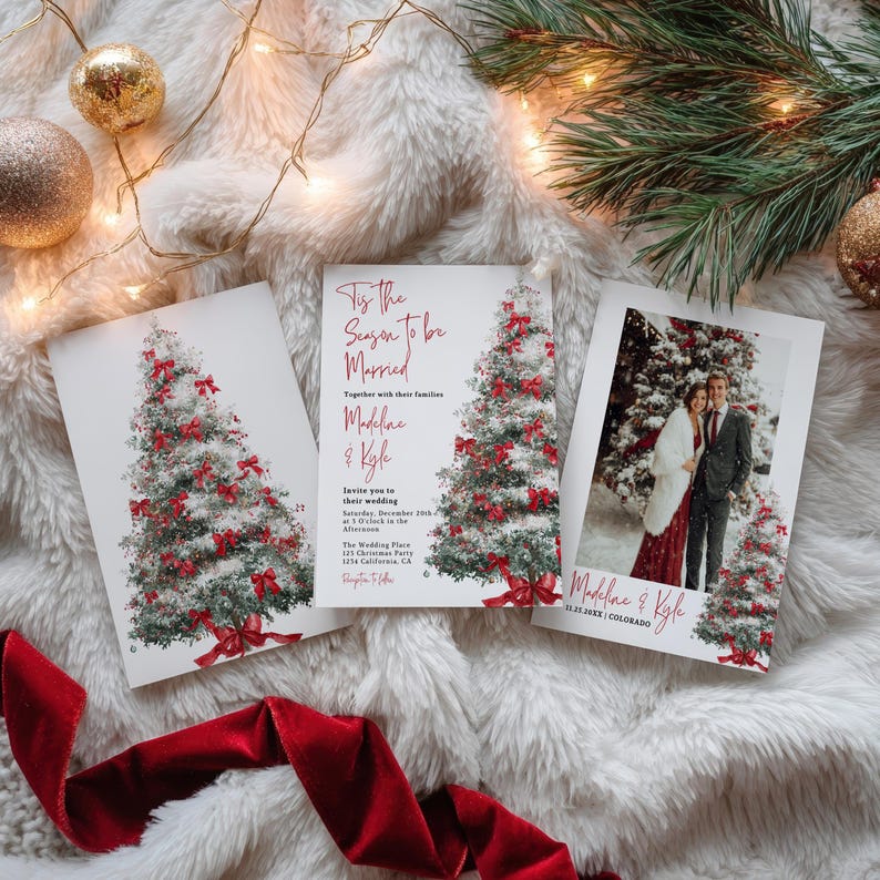 May include: Wedding invitation cards featuring a Christmas tree design with red bows and the text "Tis the Season to be Married". One card includes a photo of the couple. The cards are on a white, fluffy surface.