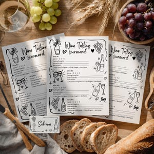 May include: Wine tasting scorecards with illustrations of wine bottles, glasses, and grapes. The cards have spaces for scoring and tasting notes. A small card with the name "Sabrina" is also present, along with bread, grapes, and wine glasses.