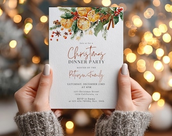 May include: A Christmas Dinner Party invitation with a festive design. The top features watercolor illustrations of dried oranges, cinnamon sticks, and greenery. The invitation text includes the event details: "Christmas Dinner Party" hosted by the Peterson Family.