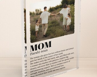 May include: A clear acrylic block with a printed photograph of a family walking in a field. The block features the word "MOM" in large letters, along with a definition and description of a mother. A thoughtful gift.