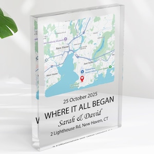 May include: A clear acrylic block featuring a map of New Haven, CT, with a blue and white color scheme. The text "WHERE IT ALL BEGAN" is displayed, along with a date and names. The block is a decorative keepsake.