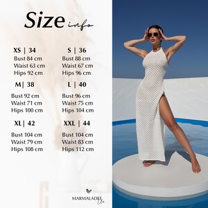 May include: A white, halter-neck maxi dress with a high slit, displayed on a model. The image includes a size chart with measurements in centimeters for bust, waist, and hips, ranging from XS to XXL. The text "Size info" is at the top.