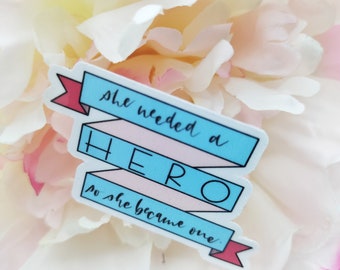 She Needed a Hero so She Became One Ribbon Style Hand Lettered Vinyl Sticker with Glossy Laminated Finish