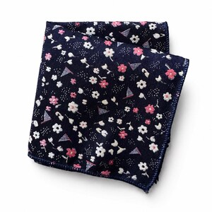 May include: A folded square pocket square in dark navy blue fabric featuring a repeating pattern of small white and pink flowers interspersed with tiny blue and white striped triangular pennant flags and subtle white dashed line accents.