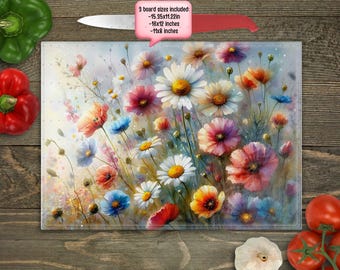 May include: A glass cutting board with a watercolor painting of a bouquet of colorful flowers, including pink, red, white, yellow, and blue flowers. The text "3 board sizes included - 15.5x11.22in - 16x12 inches - 14x8 inches" is printed on the board.