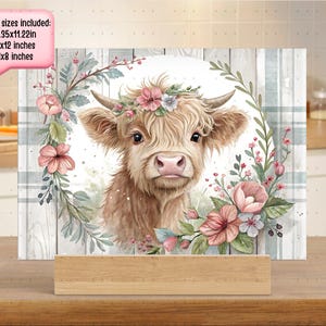 May include: A Highland cow with a floral crown, surrounded by pink and green flowers, on a white background with a woodgrain border. 3 board sizes included: -15.35x11.22in -16x12 inches -11x8 inches