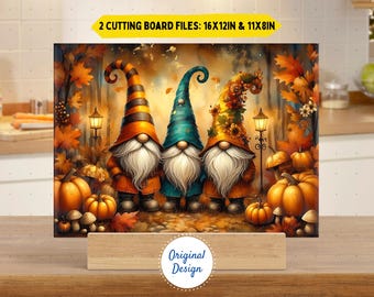 May include: A decorative cutting board featuring three gnomes with long white beards and colorful hats. The gnomes are surrounded by pumpkins, mushrooms, and autumn leaves. The text "2 Cutting Board Files: 16x12in & 11x8in" is displayed at the top.