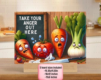 May include: A wooden cutting board with a chalkboard sign that says "Take Your Anger Out Here".  The board is decorated with three cartoon vegetables: a tomato, a carrot, and a fennel. The vegetables have faces and are expressing emotions. The board is available in three sizes: 15.35x11.22 inches, 16x12 inches, and 11x8 inches.