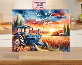 May include: A watercolor painting of a blue tractor in a field of wheat. The sun is setting in the background and the sky is a mix of pink, orange, and purple. The text "Life's much better on the farm" is written in white letters on a dark blue background.