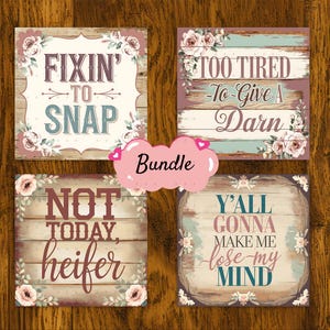 May include: A set of four rustic wooden signs with floral accents and country-themed sayings. The signs read "Fixin' to Snap", "Too Tired -To-Give A Darn", "Not Today, Heifer", and "Y'all Gonna Make Me Lose My Mind".