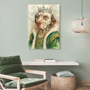 May include: Watercolor painting of a Dalmatian dog wearing a crown, pearl necklace, and green and gold royal attire. The dog has brown spots and is set against a soft, watercolor background. The artwork is displayed on a wall.