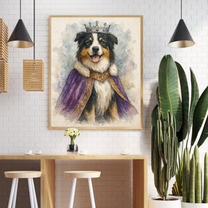 May include: Watercolor painting of a dog wearing a crown and royal purple cape with gold trim. The dog has black, white, and brown fur and is smiling. The artwork is framed in a light wood frame.