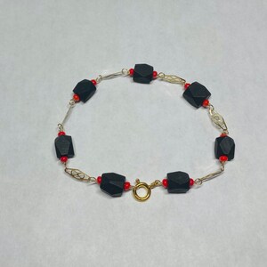 14 Karat Yellow Gold Filled Genuine 7mm Azabache Jet and Coral Accent 7.5&quot; Plaque Bracelet