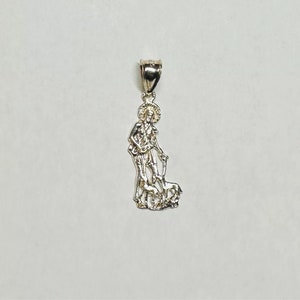 May include: A silver pendant featuring a detailed depiction of Saint Christopher carrying a child on his shoulder. The pendant is designed with a loop at the top for attaching to a chain.