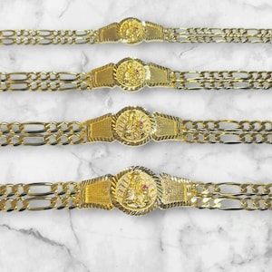 May include: Four gold-coloured bracelets, widths 5 mm, 6 mm, 7 mm, and 8 mm. Each bracelet has a central decorative element and a chain-link design. The bracelets are displayed on a marble-patterned surface.