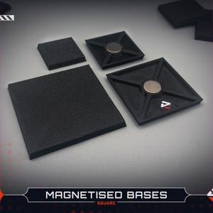 May include: A collection of black square bases featuring a textured top surface and a recessed underside with a central circular magnet. The bases are arranged in various sizes, with some showing the flat top and others showing the magnetic underside.