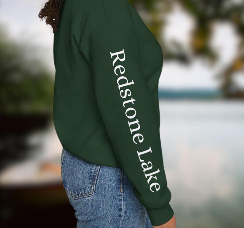 May include: A dark green sweatshirt with the text "Redstone Lake" printed in white on the left sleeve.