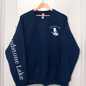 May include: Navy blue sweatshirt with white text and a graphic of Redstone Lake on the front and the words "Redstone Lake" on the left sleeve.