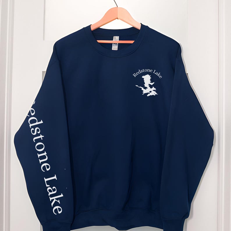 May include: Navy blue sweatshirt with white text and a graphic of Redstone Lake on the front and the words "Redstone Lake" on the left sleeve.
