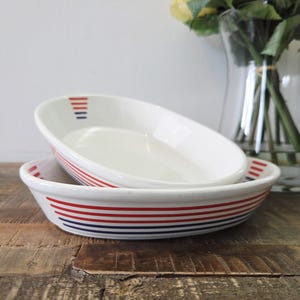 Peut inclure: Une tasse en céramique blanche avec une anse noire et le texte "But First, Coffee" dans un style manuscrit. La tasse est posée sur une surface blanche. La tasse mesure 10 cm de haut.