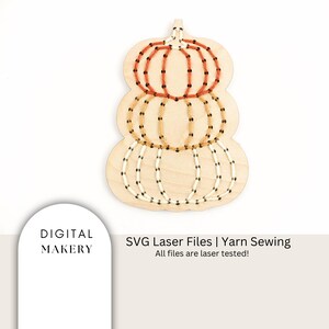 May include: A wooden pumpkin shaped craft kit with three layers of pumpkins. Each layer has a different color yarn for sewing. The yarn colors are orange, yellow, and white. The text "SVG Laser Files | Yarn Sewing" is below the image. The text "All files are laser tested!" is below the text "SVG Laser Files | Yarn Sewing".