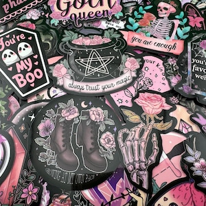 May include: A collection of colorful stickers with gothic and spooky themes. The stickers feature various designs, including a cauldron, a skeleton, a rose, a potion bottle, and text that says "You're My Boo", "Goth Queen", "Always Trust Your Magic", and "You Are Enough".