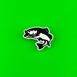 May include: Black and white silhouette of a fish jumping out of the water. The fish is facing to the right. The background is a solid green.