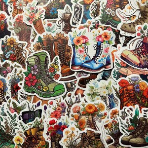 May include: A collection of colorful stickers featuring various designs of boots with floral accents. The boots are depicted in different styles and colors, with some featuring intricate floral patterns and others showcasing a more minimalist design.