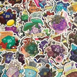 May include: A collection of colorful stickers featuring dice with different numbers and designs. The stickers are decorated with flowers, leaves, and other nature-inspired elements. Some stickers have text, including "Bard", "Cleric", "Monk", "Sorcerer", "Paladin", and "Is Nice".