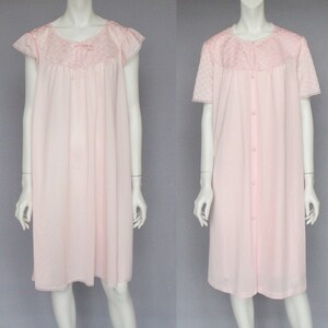 May include: Two pink nightgowns with short sleeves and lace trim. One nightgown has a button-up front.