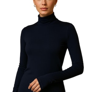 May include: A set of three ceramic mugs with a speckled, matte finish. The mugs are in shades of cream, light gray, and dark gray. Each mug has a simple, minimalist design and a rounded handle.