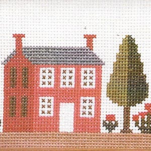 May include: A cross-stitch pattern of a red house with a gray roof, two windows on each floor, and a white door. There is a green tree to the right of the house and red flowers in front of the house.