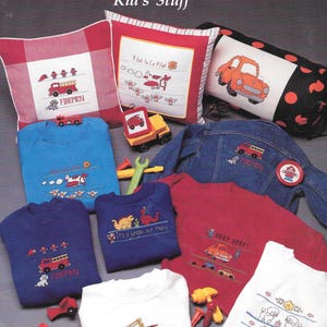 May include: A cross-stitch pattern booklet featuring designs for children's clothing and home decor. The designs include a fire truck, a pilot, a car, a dinosaur, a poodle, and a construction truck. The booklet is titled "This and That... Kid's Stuff" and is designed by Julia Thorp Bailey.